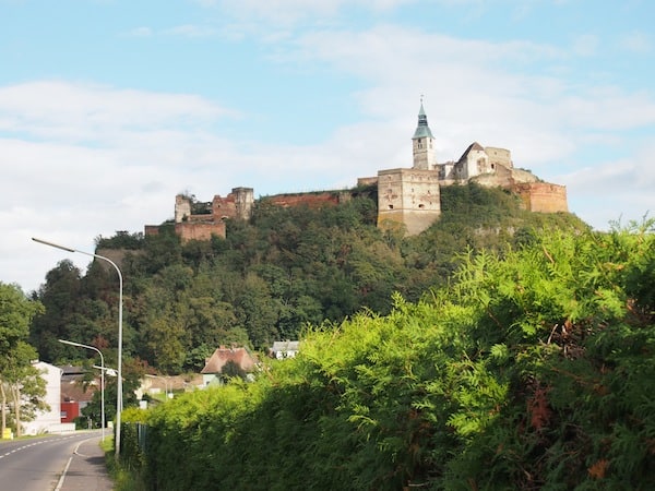 The palace of Güssing can already be seen from afar, towering above its extinct volcanic hill.