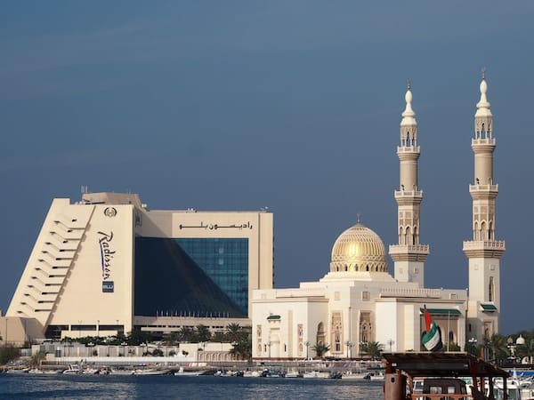 Modern-day culture in Sharjah greets us to a fusion of many worlds, as exemplified by this five star Radisson Blu Hotel against one of the many beautiful Mosques around here next to it.